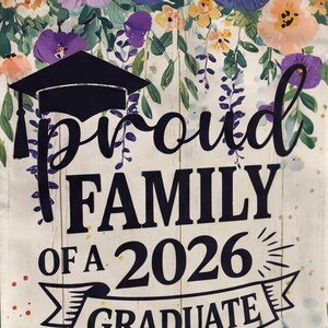 May include: A graduation-themed sign with the words "Proud Family of a 2026 Graduate" in black script. The sign features a graduation cap and is decorated with floral elements in shades of purple, orange, and yellow. The background has a wood-like texture.