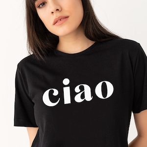 May include: A black t-shirt with a white graphic that says "ciao" in a bold, retro font.
