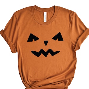 ジャック・オー・ランタンの顔のシャツ、ハロウィン T シャツ、ハロウィン シャツ、カボチャのジャック・オー・ランタン T シャツ、カボチャの顔、ジャック・オー・ランタン シャツ、秋の T シャツ