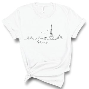 May include: White t-shirt with a black line drawing of the Eiffel Tower and the word "Paris" underneath.