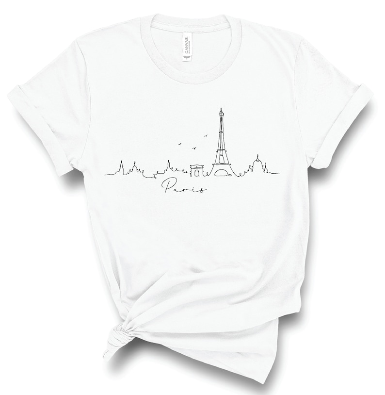 May include: White t-shirt with a black line drawing of the Eiffel Tower and the word "Paris" underneath.