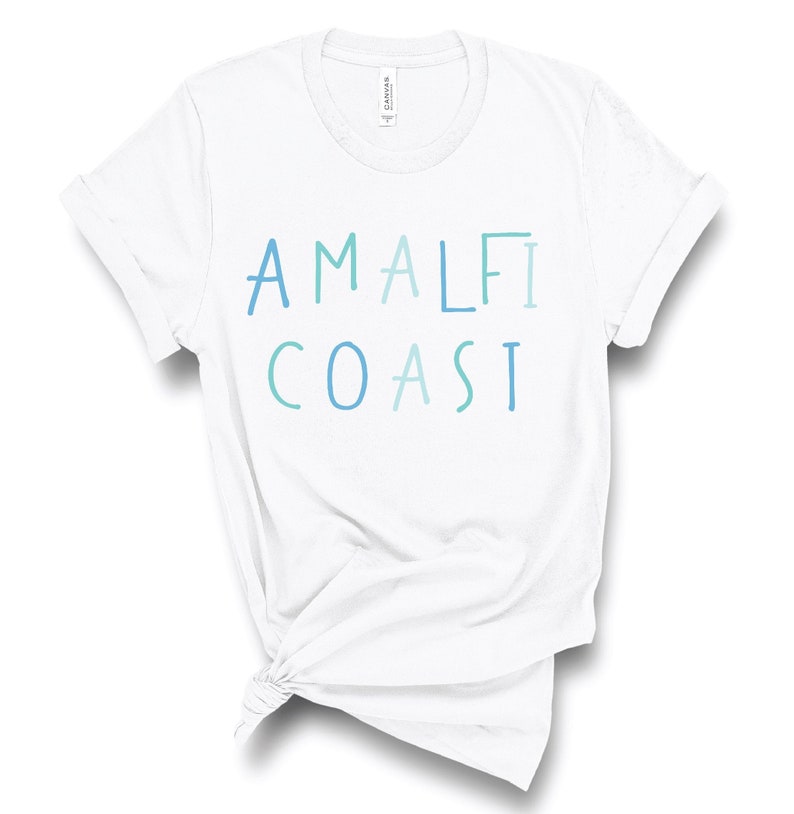 May include: White t-shirt with the text "Amalfi Coast" in blue and green lettering.
