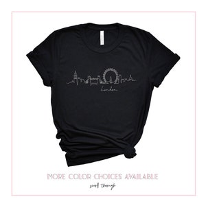May include: Black t-shirt with a white outline of the London skyline, including Big Ben, the London Eye, and Tower Bridge. The text "London" is written below the skyline.