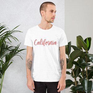 May include: White t-shirt with the word "California" written in red cursive lettering.