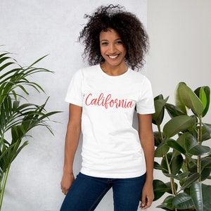 May include: White t-shirt with the word "California" written in red cursive lettering.