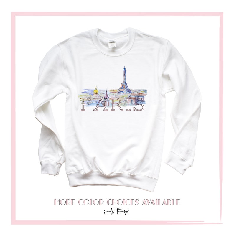 May include: White long-sleeve sweatshirt with a watercolor illustration of the Eiffel Tower and the word "PARIS" printed on the front.