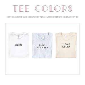 Puede incluir: Tres camisetas dobladas en diferentes colores: blanco, gris claro y crema claro. El texto "TEE COLORS" est&aacute; en la parte superior de la imagen. El texto "DON'T SEE WHAT YOU ARE LOOKING FOR? MESSAGE US FOR OTHER SHIRT COLORS AND STYLES." est&aacute; debajo de las camisetas.