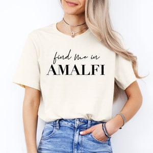 May include: A white t-shirt with black text that reads "find me in AMALFI".
