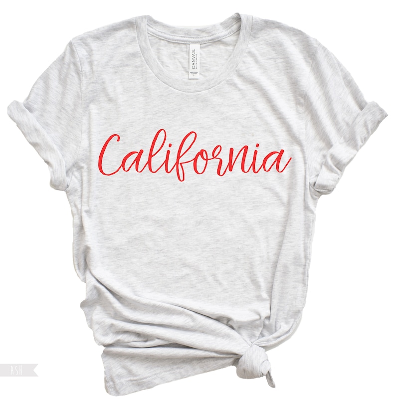 May include: A heather grey t-shirt with the word "California" written in red cursive.