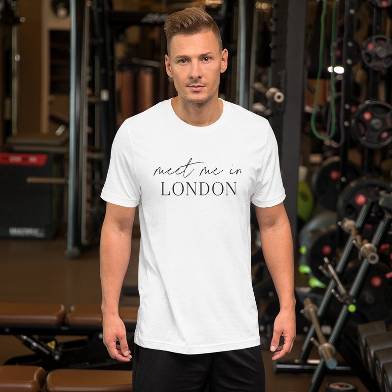 May include: White t-shirt with black text that reads "meet me in LONDON" in a cursive font.