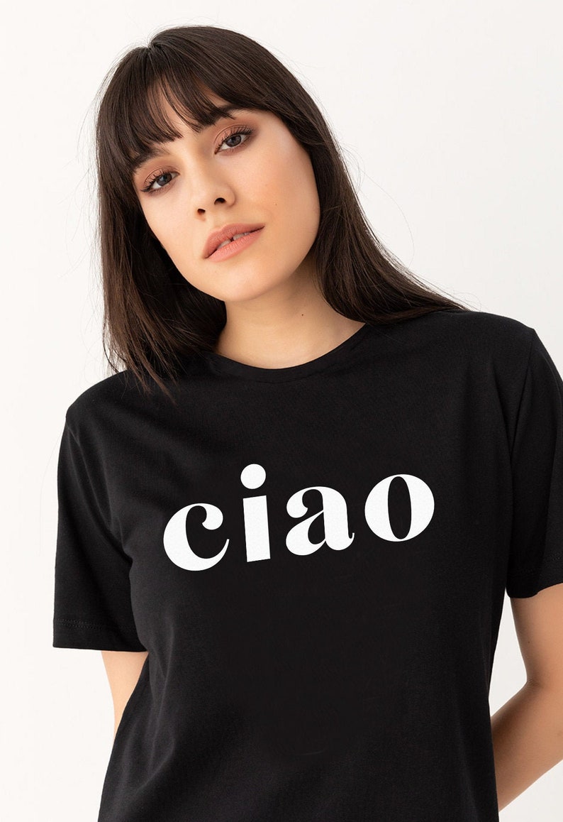 May include: A black t-shirt with a white graphic that says "ciao" in a bold, retro font.