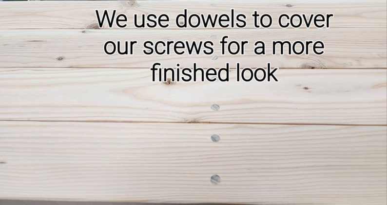May include: Close-up of light-colored wooden planks with visible wood grain. The text reads, "We use dowels to cover our screws for a more finished look." Several screws are visible, covered with dowels.