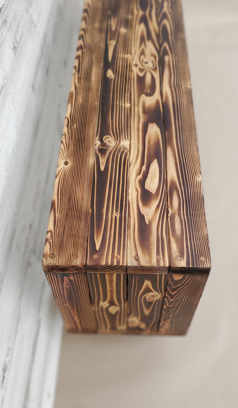 May include: A rustic wooden box with a dark brown finish. The box is made of reclaimed wood and has a natural wood grain pattern. The box is perfect for storing small items or displaying decorative items.