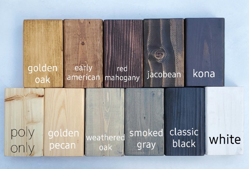 May include: A collection of wooden blocks showcasing various wood stain colors. Colors include golden oak, early American, red mahogany, and jacobean. Additional colors are kona, golden pecan, weathered oak, smoked gray, classic black, and white.