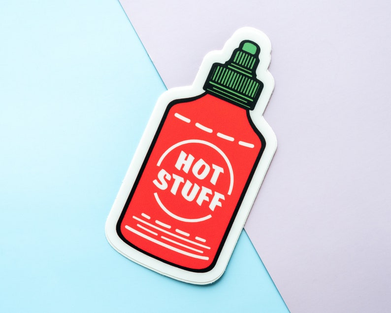 May include: A red and white sticker of a hot sauce bottle with the text "HOT STUFF" in a circle on the label.