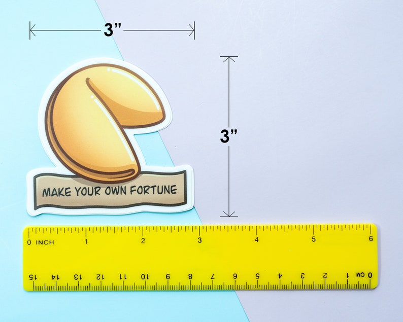 May include: A white sticker with a yellow fortune cookie illustration and the text "Make your own fortune". The sticker is 3 inches wide and 3 inches tall.