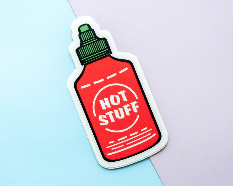May include: A red and white hot sauce bottle sticker with a green lid and the text "HOT STUFF" in a white circle.