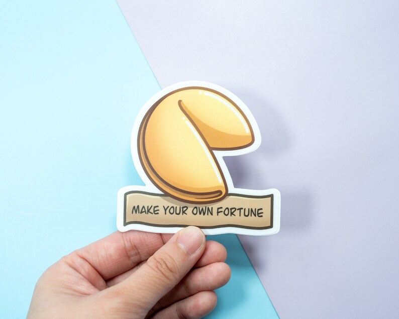 May include: A white sticker with a cartoon illustration of a fortune cookie and the text "Make your own fortune".