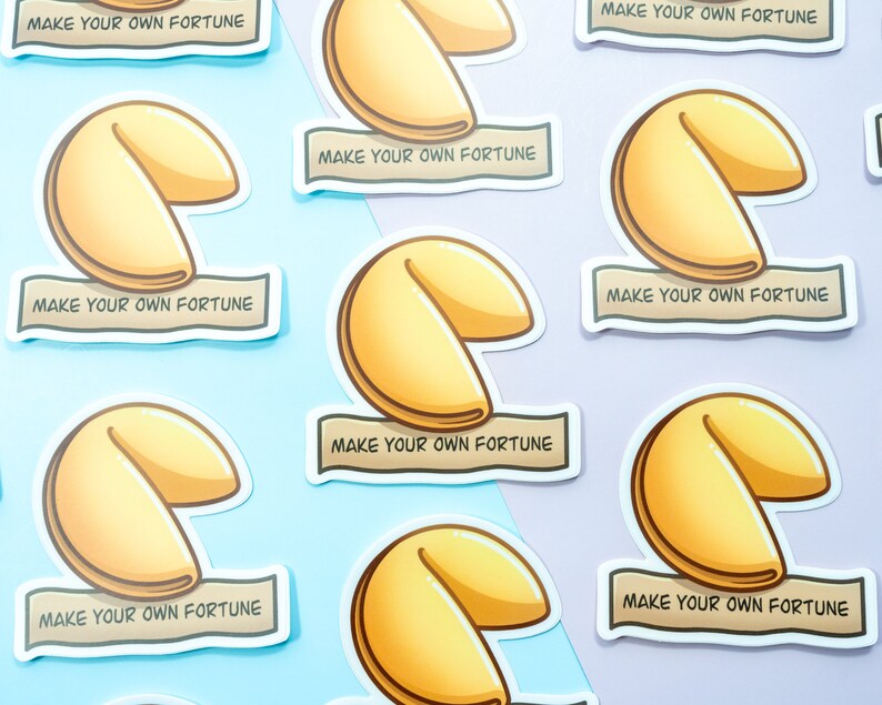 May include: Nine fortune cookie stickers with the text "Make your own fortune" on each. The stickers are on a light blue and purple background.