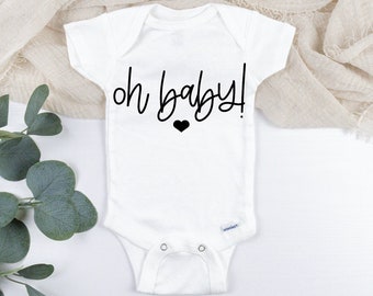 May include: White baby onesie with black text that reads "oh baby!" and a small black heart.