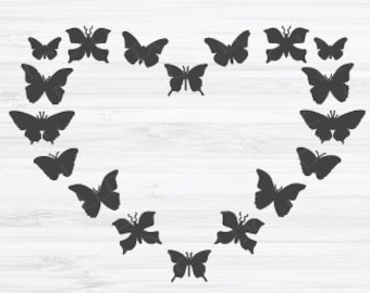 May include: A heart shape made of black butterflies on a white wood background.
