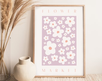 May include: A framed print with a light purple background and a pattern of white flowers with pink centers. The text "FLOWER MARKET" is printed in white at the top and bottom of the print.