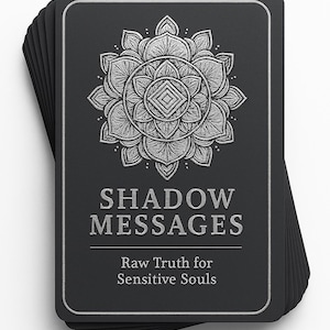 May include: A deck of black cards with silver text and a detailed floral design. The card on top reads "SHADOW MESSAGES" and "Raw Truth for Sensitive Souls". The cards have rounded corners and a white background.