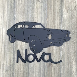 May include: Black metal silhouette of a classic Chevrolet Nova car with the word "Nova" written underneath.
