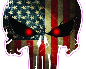 May include: A skull graphic with the American flag design. The skull has red eyes and the flag is distressed and faded.