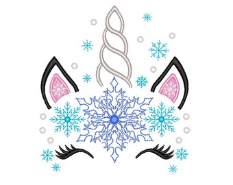 May include: A whimsical unicorn face design with a silver horn, black ears with pink inner details, and closed eyelashes. The design features a large blue snowflake and smaller blue snowflakes, with white accents, all set against a white background.