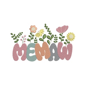 May include: Embroidered design featuring the word "MEMAW" in bubble letters, with colorful flowers and green leaves sprouting from the letters. The letters are in shades of pink, blue, orange, and gray, with a white background.