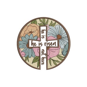 May include: A round embroidery design featuring a cross with the words "He is risen, he is not here" surrounded by colorful flowers.