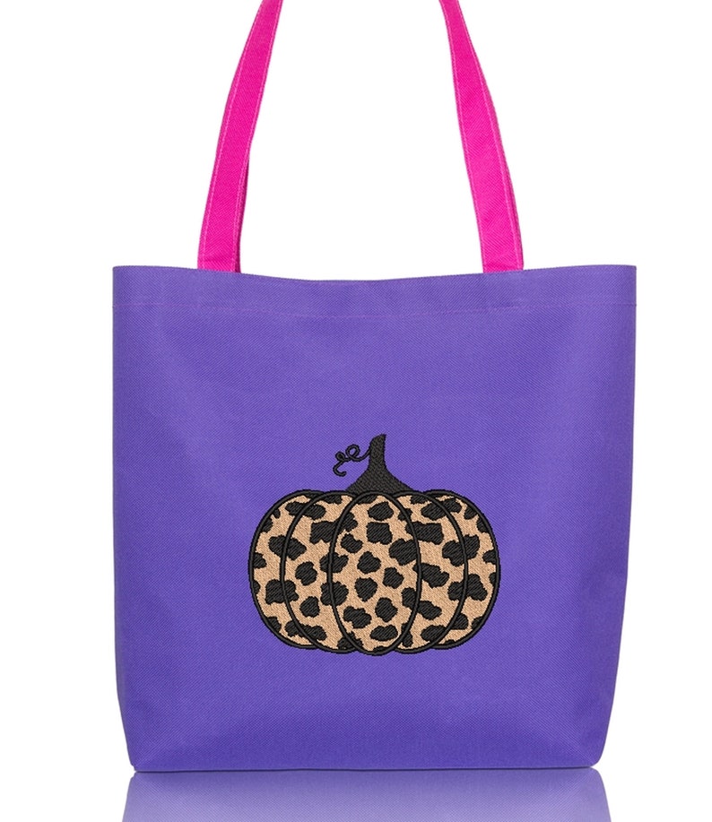May include: Purple tote bag with pink handles and a black embroidered leopard print pumpkin.