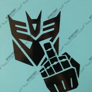 May include: Black vinyl decal of the Transformers Autobot symbol with a raised middle finger. The decal is on a light blue background.
