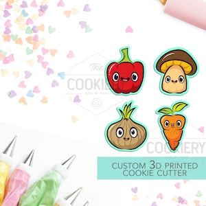 May include: A collection of custom 3D printed cookie cutters featuring cartoon vegetables: a red pepper, mushroom, onion, and carrot. The image also includes a pink rolling pin, frosting bags, and heart-shaped sprinkles.