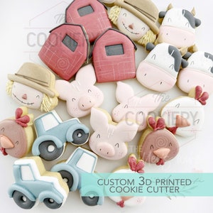 May include: A set of 3D printed cookie cutters featuring farm animals, a barn, a tractor, and a scarecrow. The cutters are made of white plastic and have a smooth finish.  "CUSTOM 3D PRINTED COOKIE CUTTER" is printed on the bottom of the image.