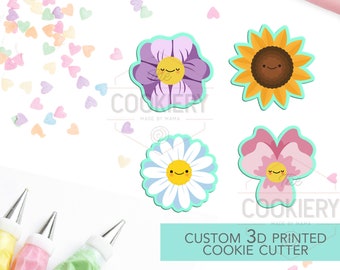 May include: Four 3D printed cookie cutters shaped like flowers with happy faces. The cutters are purple, yellow, white, and pink. The text "CUSTOM 3D PRINTED COOKIE CUTTER" is on a turquoise background.