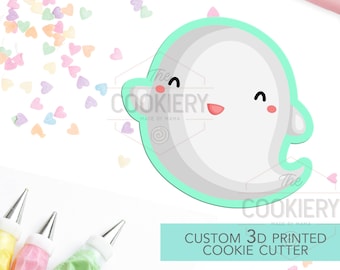 May include: A custom 3D printed cookie cutter in the shape of a smiling ghost. The cutter is light green and white with a light gray outline. The text "CUSTOM 3D PRINTED COOKIE CUTTER" is in white on a light green background.