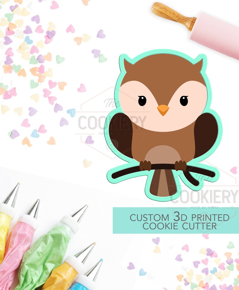 May include: A brown and white owl cookie cutter with a branch. The cutter is 3D printed and is a custom design. The text "CUSTOM 3D PRINTED COOKIE CUTTER" is on a light blue background.