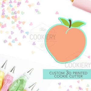 May include: A 3D printed peach cookie cutter, with a light green stem and leaves, on a white background with pastel pink, yellow, and blue heart sprinkles. The text "Custom 3D Printed Cookie Cutter" is in a turquoise box.