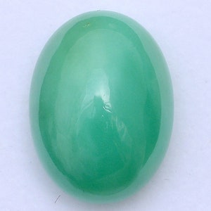 May include: A smooth, oval-shaped green gemstone with a high polish.