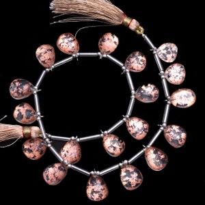 May include: A strand of copper-infused quartz gemstone beads in a teardrop shape. The beads are strung on silver-toned wire and have a natural, irregular shape.
