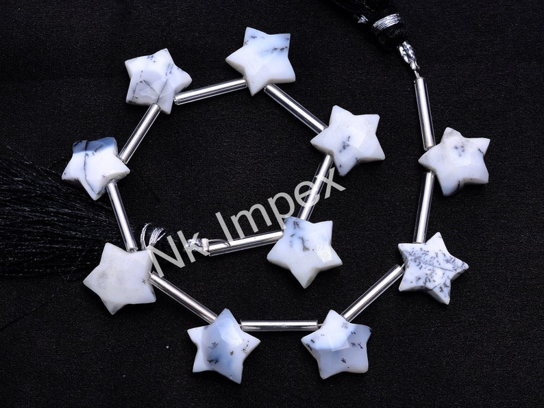 May include: A strand of white opal star-shaped beads with silver spacers. The beads are strung on a black cord with a black tassel.