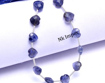 May include: A strand of blue gemstone heart-shaped beads on a silver wire. The beads are faceted and have a shimmery, iridescent quality. The strand is approximately 40 cm long and is perfect for making jewellery.