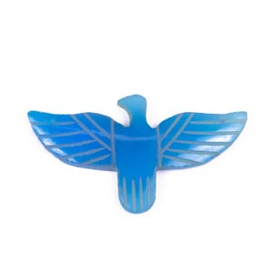May include: A blue agate carving of a bird with outstretched wings. The carving is detailed with lines and a textured surface.