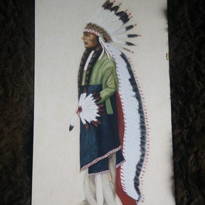 May include: A painting of a Native American man wearing a traditional headdress with white feathers and a green and blue outfit. The man is holding a fan of feathers in his right hand.