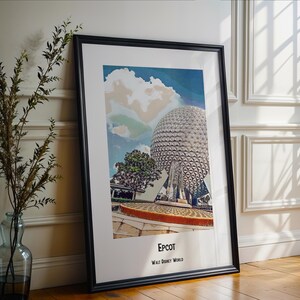 May include: A framed print of a colorful illustration of Epcot's Spaceship Earth, a geodesic sphere, at Walt Disney World. The print has a blue, green, and white background with a white cloud.