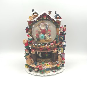 Vintage Grandeur Noel Christmas Musical Animated Water Glitter Snowglobe Santa Claus And Elves In Toy Workshop Plays The Song "Jingle Bells"