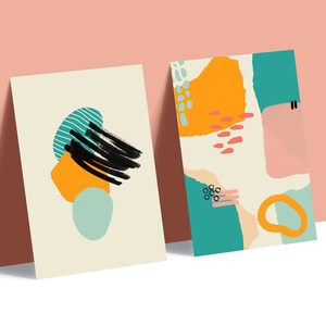 May include: Two abstract art prints with colorful shapes and patterns. The print on the left features a black brushstroke, a yellow shape, and a blue and green shape. The print on the right features a variety of shapes in orange, pink, blue, and green.
