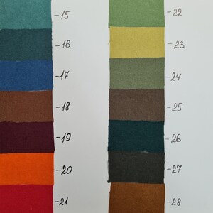 May include: A colour swatch chart featuring two vertical columns of rectangular fabric samples in various shades including teal, blue, brown, burgundy, orange, red, green, yellow, olive, and charcoal, each labelled with numbers 15 through 28.